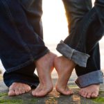 Man and woman touching feet