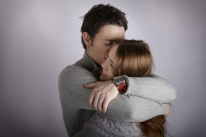 Man hugging woman