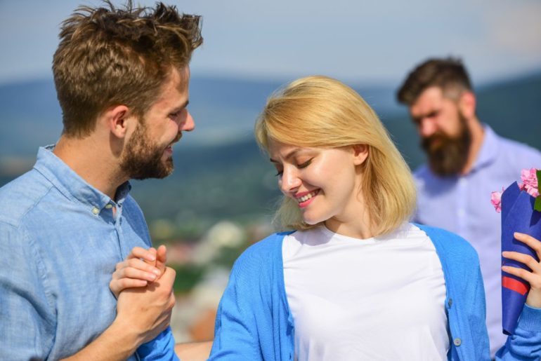 Woman holding hands with different man