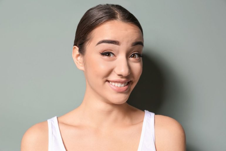 Woman raising eyebrows and smiling