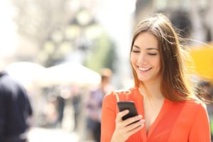 Woman smiling texting