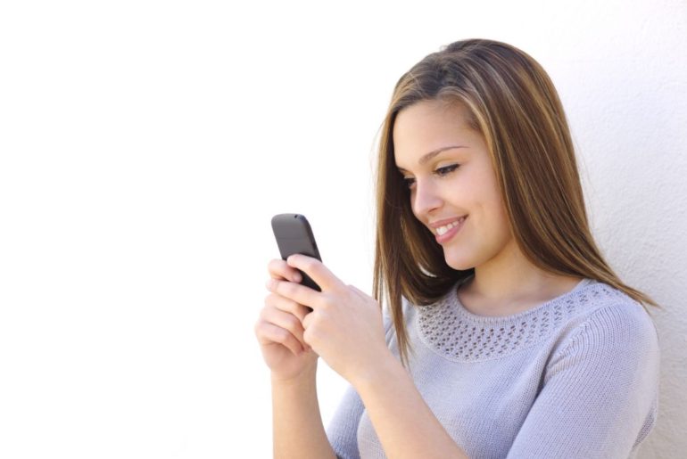 Woman texting smiling